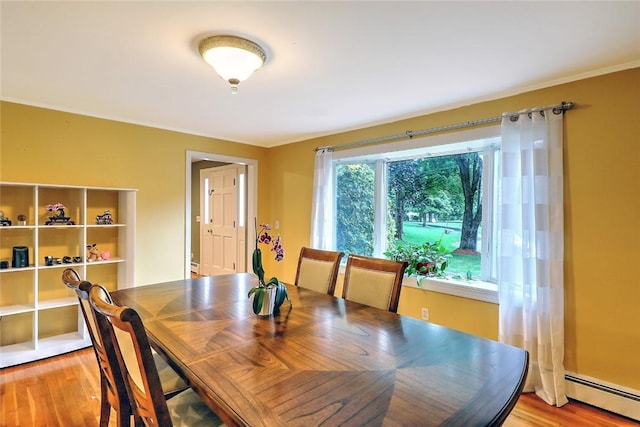 dining room featuring light hardwood / wood-style flooring and a baseboard radiator