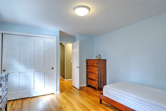 bedroom with a closet and light hardwood / wood-style flooring