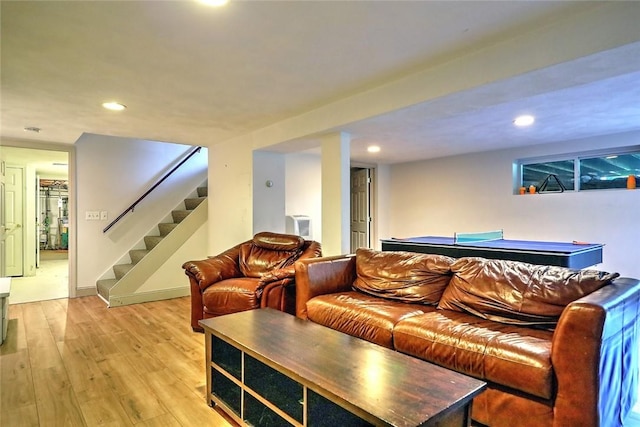 living room with pool table and light hardwood / wood-style floors