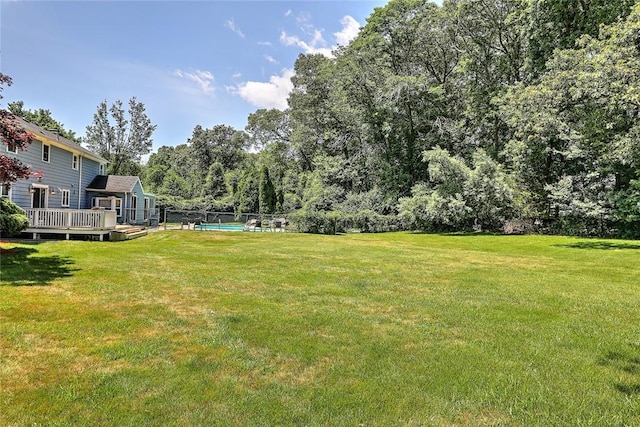 view of yard with a swimming pool side deck