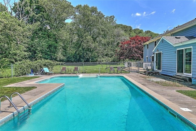 view of pool featuring a patio area and a lawn