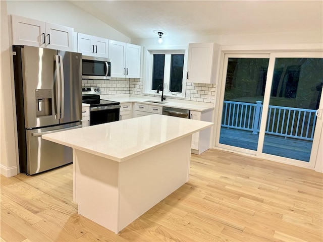 kitchen with decorative backsplash, sink, white cabinetry, and appliances with stainless steel finishes