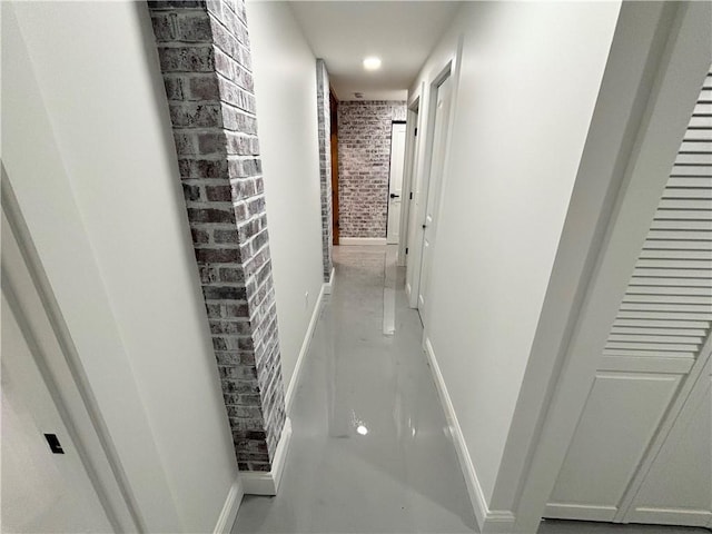 corridor featuring brick wall