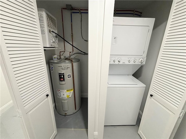 clothes washing area featuring electric water heater and stacked washer / drying machine