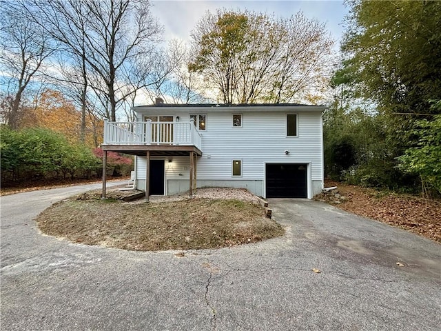 view of front of property featuring a garage and a wooden deck