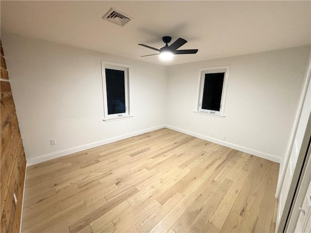 empty room with ceiling fan and light hardwood / wood-style floors