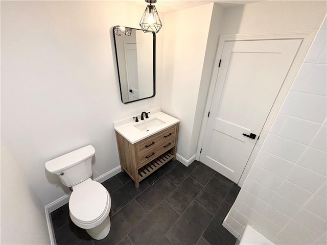 bathroom featuring tile patterned floors, toilet, and vanity