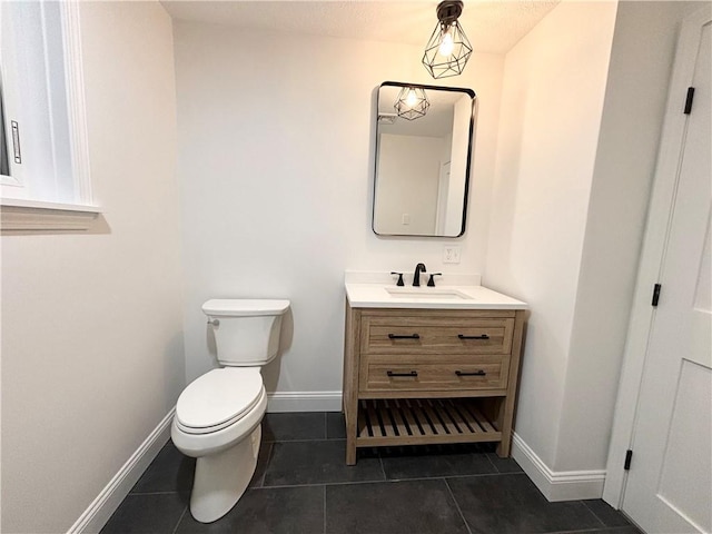 bathroom featuring toilet, tile patterned floors, and vanity