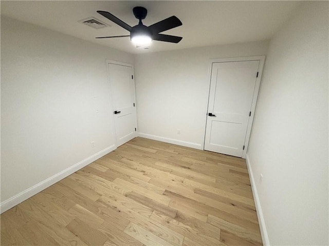 unfurnished room with ceiling fan and light wood-type flooring