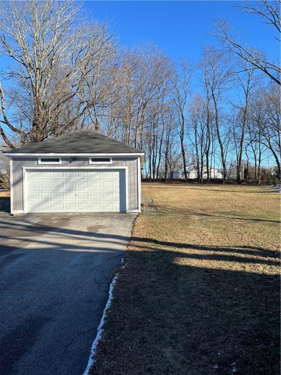 garage featuring a yard