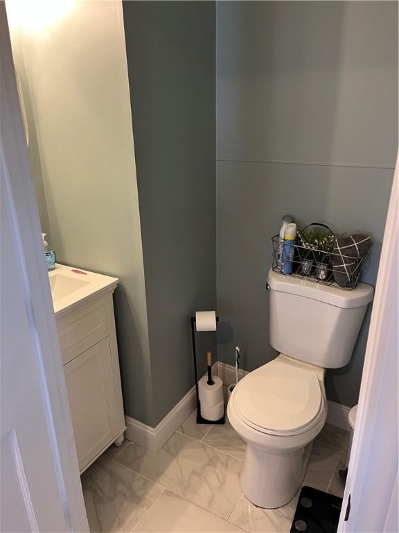 bathroom featuring toilet and vanity