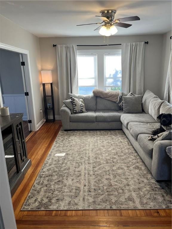 living room with ceiling fan and hardwood / wood-style flooring