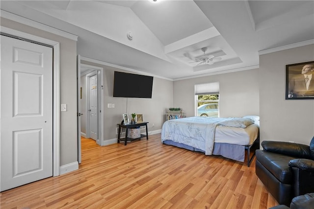 bedroom with ornamental molding and light hardwood / wood-style floors