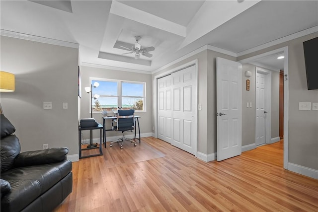 office space featuring ceiling fan, crown molding, and light wood-type flooring