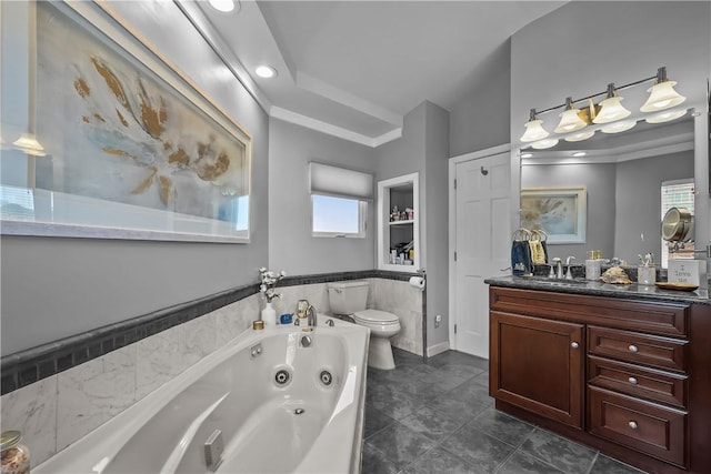 bathroom with built in shelves, vanity, a tub, toilet, and crown molding