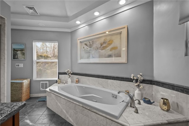 bathroom with tiled bath and vanity