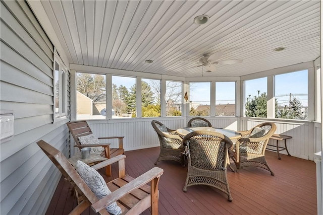 sunroom with ceiling fan, a wealth of natural light, and wood ceiling