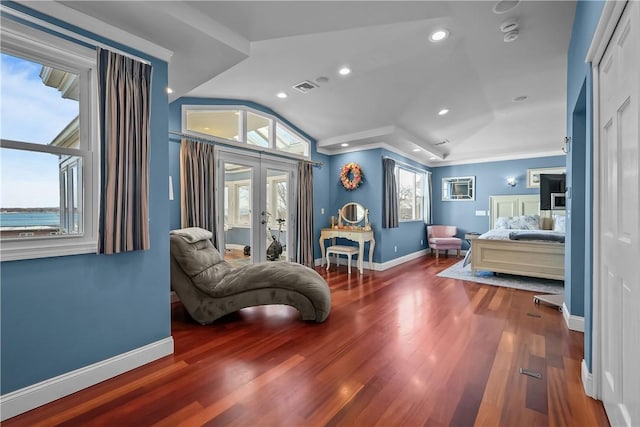 bedroom featuring hardwood / wood-style flooring, crown molding, french doors, and vaulted ceiling