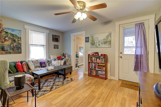 living room featuring ceiling fan, light hardwood / wood-style flooring, and a healthy amount of sunlight