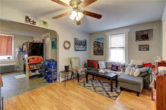 living room with ceiling fan, radiator heating unit, and hardwood / wood-style floors