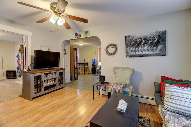 living room with ceiling fan, hardwood / wood-style floors, and a baseboard radiator