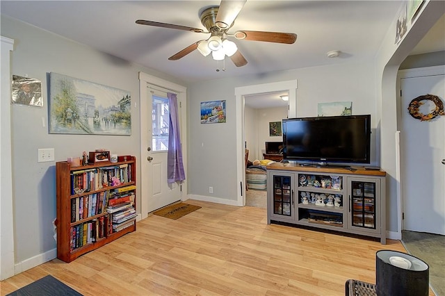 living room featuring ceiling fan and light hardwood / wood-style floors