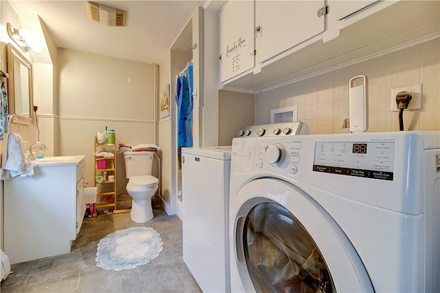 washroom with washer and clothes dryer and sink