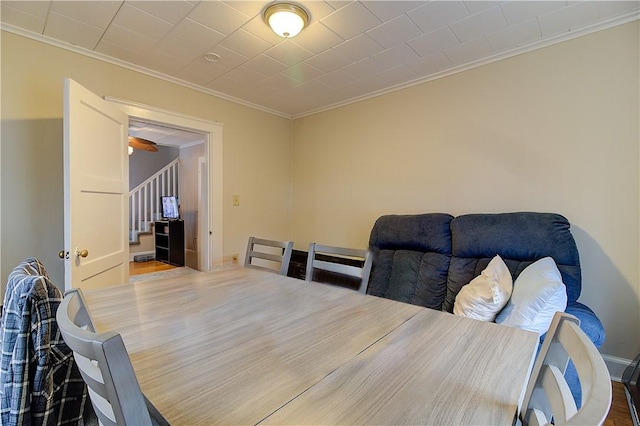 dining space with ornamental molding