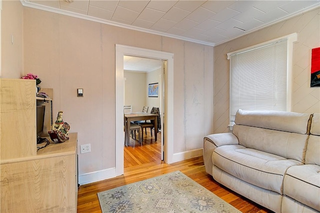 living area featuring ornamental molding and hardwood / wood-style floors