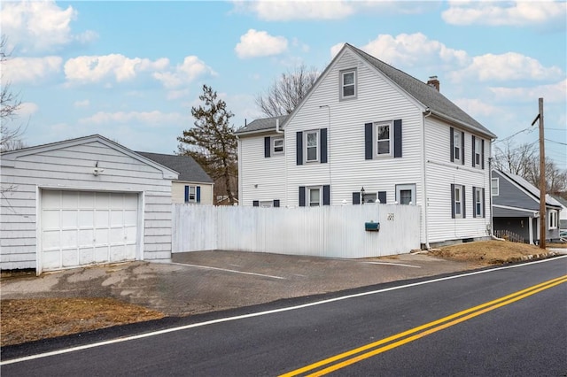 view of front of property featuring an outdoor structure and a garage