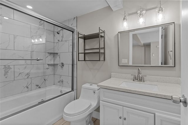 full bathroom featuring combined bath / shower with glass door, vanity, and toilet