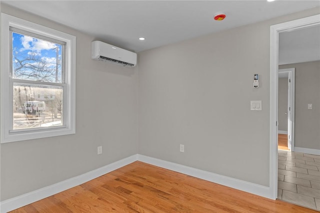 empty room with light wood-type flooring and an AC wall unit