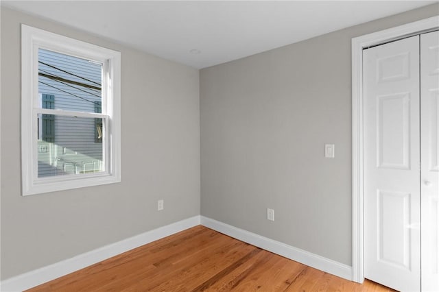 empty room featuring wood-type flooring and a wealth of natural light