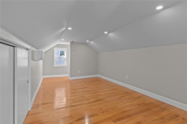 additional living space with lofted ceiling and light hardwood / wood-style floors