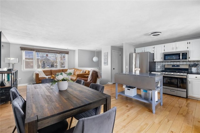 dining area featuring light wood-type flooring