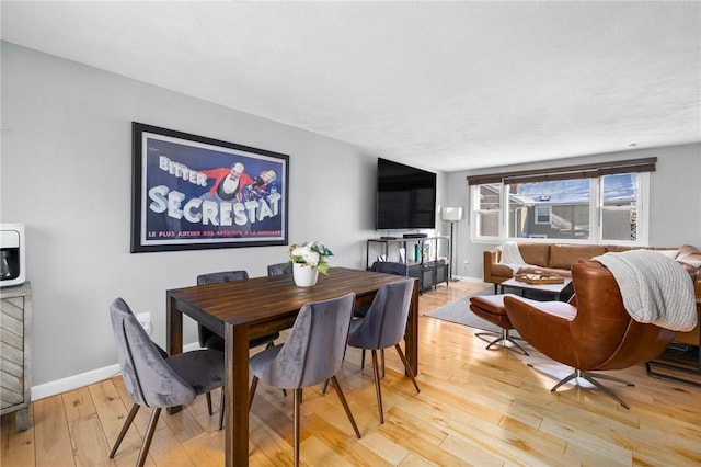 dining area with light hardwood / wood-style floors