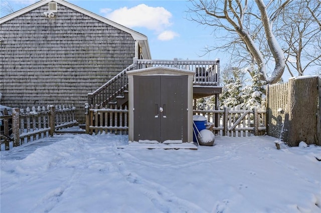 snow covered property with a storage unit