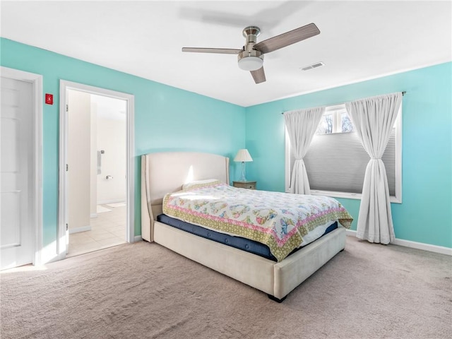 carpeted bedroom featuring ceiling fan and ensuite bathroom