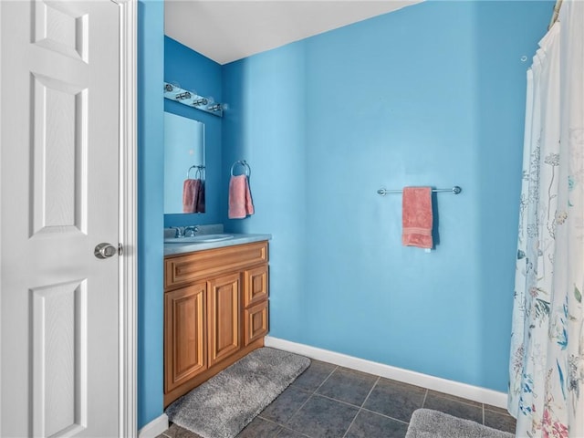 bathroom with curtained shower, vanity, and tile patterned flooring