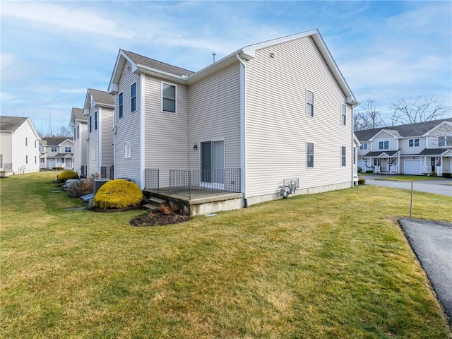 back of house featuring a lawn