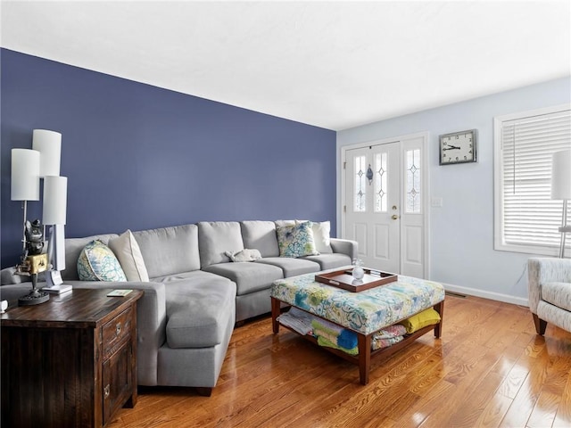 living room with a wealth of natural light and hardwood / wood-style floors