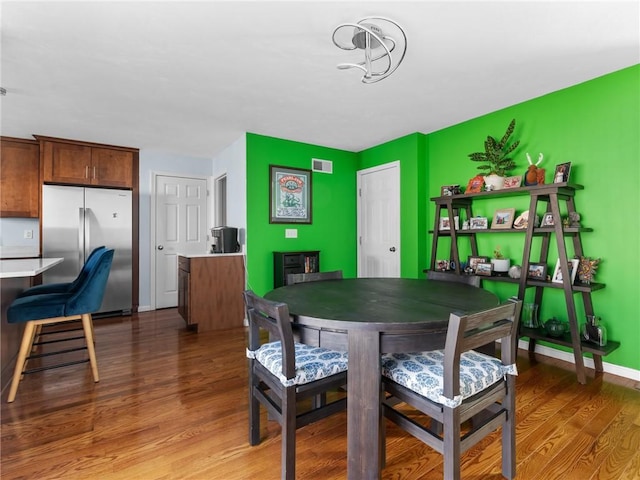 dining space with hardwood / wood-style flooring