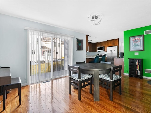 dining area featuring dark hardwood / wood-style flooring