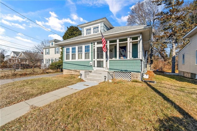 bungalow-style house featuring a front yard