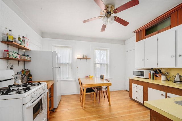 kitchen with ceiling fan, white cabinets, white appliances, and light hardwood / wood-style flooring