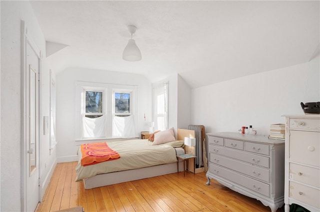 bedroom with light hardwood / wood-style flooring and vaulted ceiling