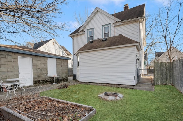 rear view of house with a yard