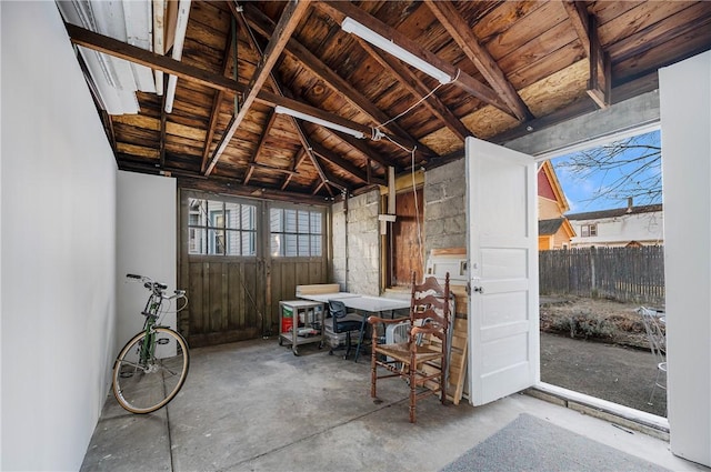 miscellaneous room featuring concrete floors, wood ceiling, and vaulted ceiling