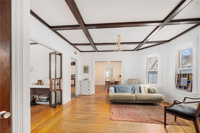 living room featuring beam ceiling, light hardwood / wood-style floors, coffered ceiling, and a notable chandelier