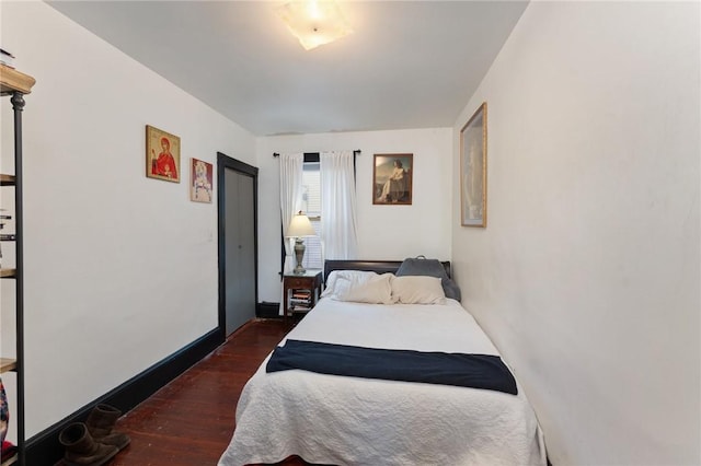 bedroom with dark wood-type flooring